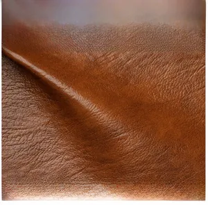 Close-up of premium brown faux leather texture with soft natural grain and elegant folds
