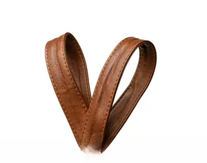 Detailed macro view of the brown lychee texture leather handle with reinforced stitching