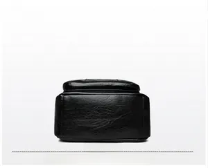 Detail shot of the black leather backpack base with lychee grain texture and stitching