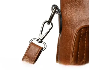 Detail of multi-layer plated metal hooks and stitching on brown soft leather tote bag