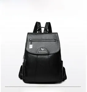 Close-up of black litchi grain leather backpack with metallic kangaroo logo detail