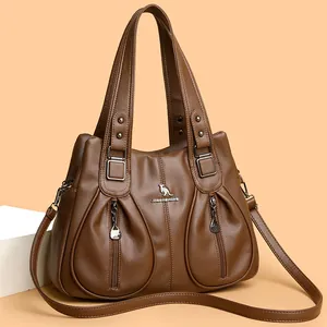 Brown textured leather crossbody handbag with double handles and metallic kangaroo logo