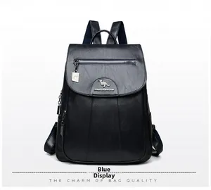 Detail view of the blue faux leather backpack with metallic kangaroo logo and front pocket
