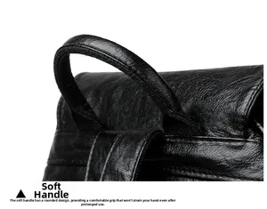 Macro detail of the soft rounded handle with reinforced stitching on black leather bag