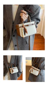 Close-up of vintage check pattern tote with decorative wooden bead charm and brown leather trim