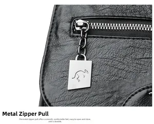 Close-up of black pebble leather backpack with silver zipper and kangaroo logo charm