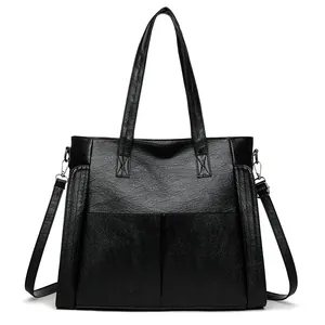 Classic black soft leather tote bag for women with dual handles and long shoulder strap