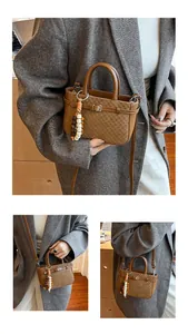 Detail view of vintage brown crossbody bag with checkered texture and beaded charm accessory
