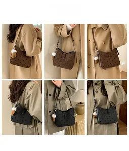 Detail showing polka dot wool shoulder bags with leather trim and plush glove pendant