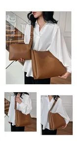 Detail of caramel leather tote bag set with small pouch on a warm indoor staircase background