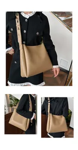 Detail view of khaki leather tote featuring adjustable wide strap and matte finish