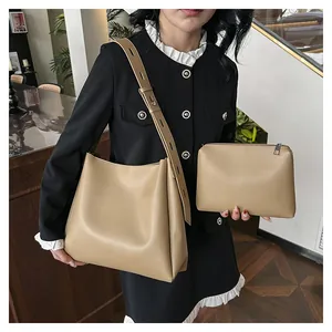 Detail view of beige tote bag set with adjustable shoulder strap and matching pouch