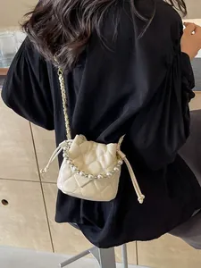 Quilted bucket bag with pearl handle and metal chain strap for women in cream
