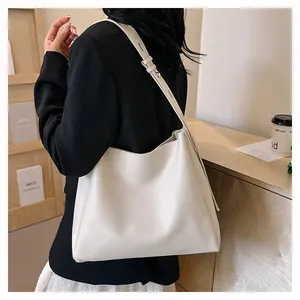 Detailed side view of white minimalist leather tote bag with adjustable silver buckle strap