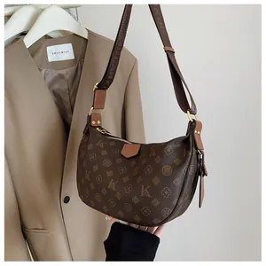 Close-up of vintage monogram hobo bag in dark brown with wide adjustable shoulder strap