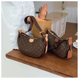 Detail of classic brown monogram half-moon bags with textured leather and wide strap