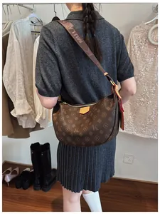 Detail of vintage brown monogram hobo bag with a wide jacquard textile strap and red edge
