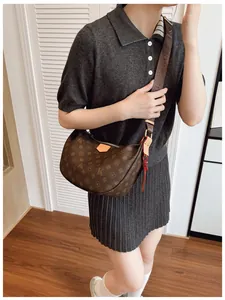 Detail of hobo crossbody bag with classic brown pattern and adjustable wide strap