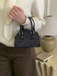 Retro grey polka dot baguette handbag with black leather handles and silver hardware