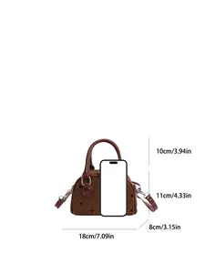 Brown polka dot tweed baguette handbag with size dimensions and phone scale reference