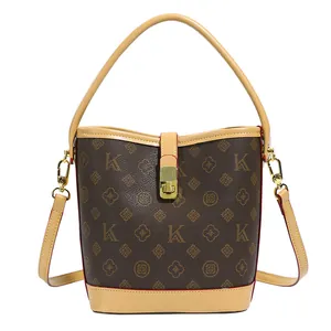 Brown monogram bucket bag with vintage prints and golden hardware accessories