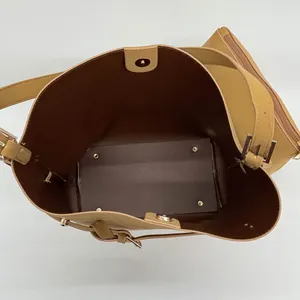 Detail of spacious khaki bucket bag interior with magnetic closure and inner pouch