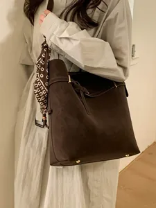Minimalist large brown suede tote bag with printed silk scarf and gold hardware accents