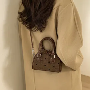 Vintage brown polka dot doctor bag in tweed with sleek top handles and crossbody strap