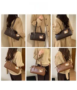 Detail view of retro tote bag in brown and caramel with plush bear charm