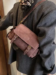 Vintage dark brown suede shoulder bag for women with leather strap and buckle detail