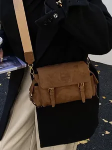 Retro dark brown suede messenger bag with decorative buckles and wide woven shoulder strap
