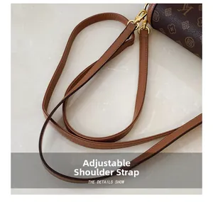 Detail shot of the adjustable brown leather strap with polished gold-tone metal buckles