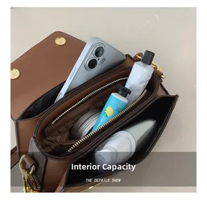 Macro view of inner compartments showing storage capacity for phone and cosmetics