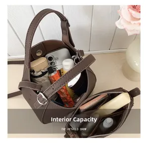 Macro view of interior storage capacity in brown pebbled leather bucket handbag
