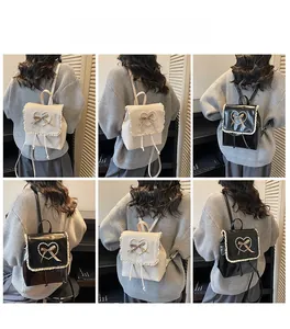 Detail view of mini PU leather backpacks with pearl heart and lace trim on models