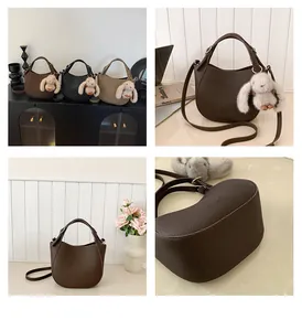 Detail showing lychee grain leather bags in various colors with rabbit charm and straps