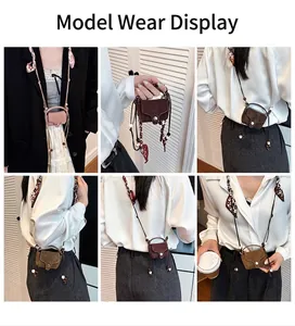 Close-up of mini crossbody square bag featuring silk scarf handle and magnetic snap button