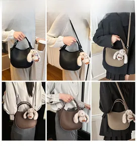 Three bucket bags in black, dark brown, and khaki with cute plush rabbit pendants