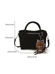 Minimalist black faux suede bucket bag with adjustable strap and cute monster charm