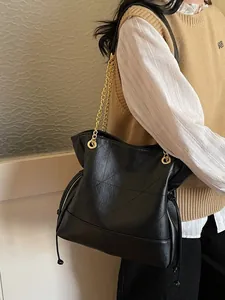 Chic black quilted tote bag with gold chain strap and drawstring for women's daily commute