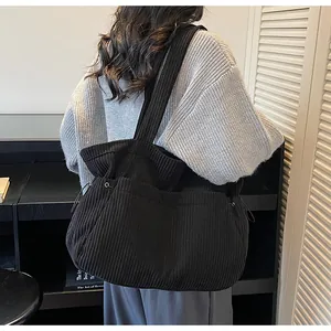 Detail showing the black corduroy texture and side drawstring of this large tote bag