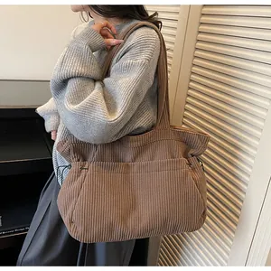 Brown corduroy tote bag showing side drawstring detail and soft ribbed texture on shoulder