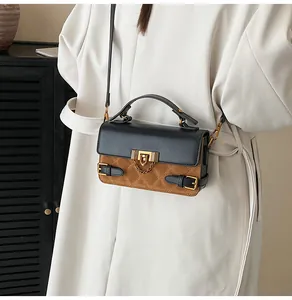 Quilted crossbody bag detail featuring black-brown contrast leather and gold buckle