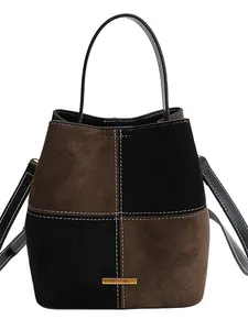 Retro color-block denim bucket bag with brown and black suede panels and metal logo