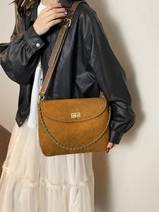 Brown quilted suede tote bag with golden chain and twist lock for casual daily styling