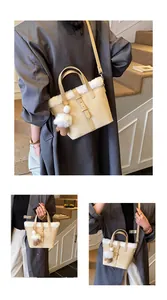 Detail showing plush faux fur trim and suede texture on this elegant beige bucket bag