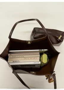 Top view of spacious brown bucket tote bag showing inner laptop and umbrella storage