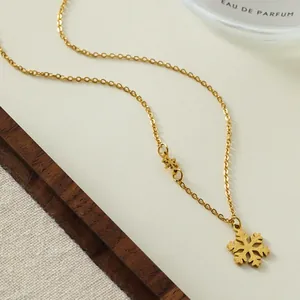 Elegant gold titanium steel necklace featuring a snowflake pendant on a fine cross chain