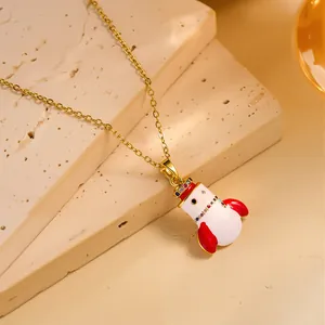 Detail of a gold necklace featuring a colorful rocket pendant with a jeweled crown on stone