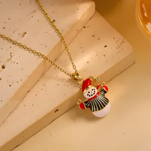 Detailed view of Christmas snowman pendant on golden stainless steel necklace